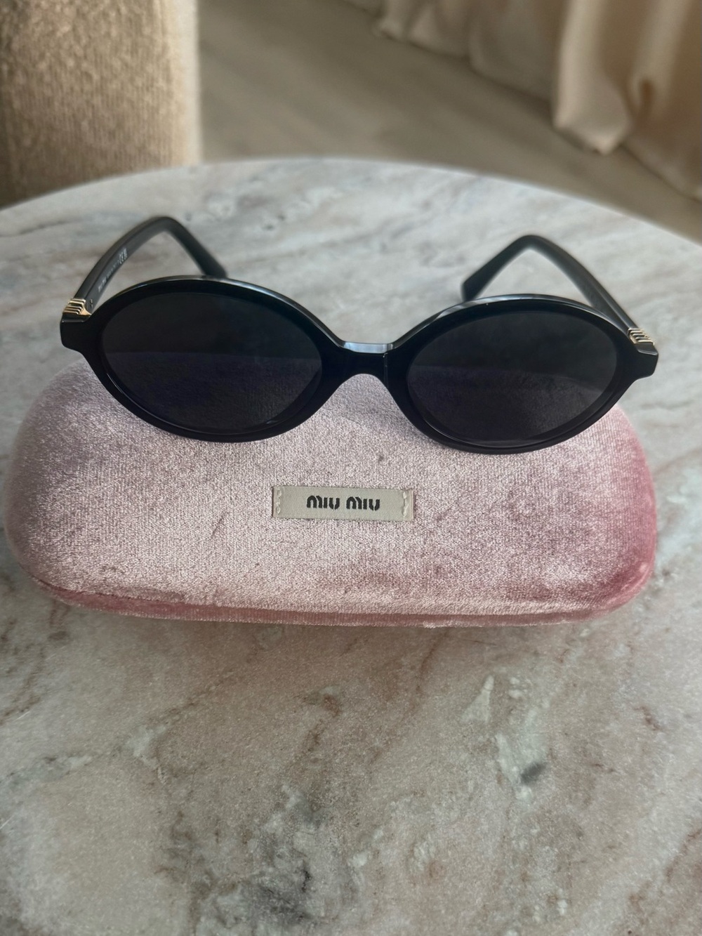 Miu Miu Black Oval Sunglasses with Dark Lenses